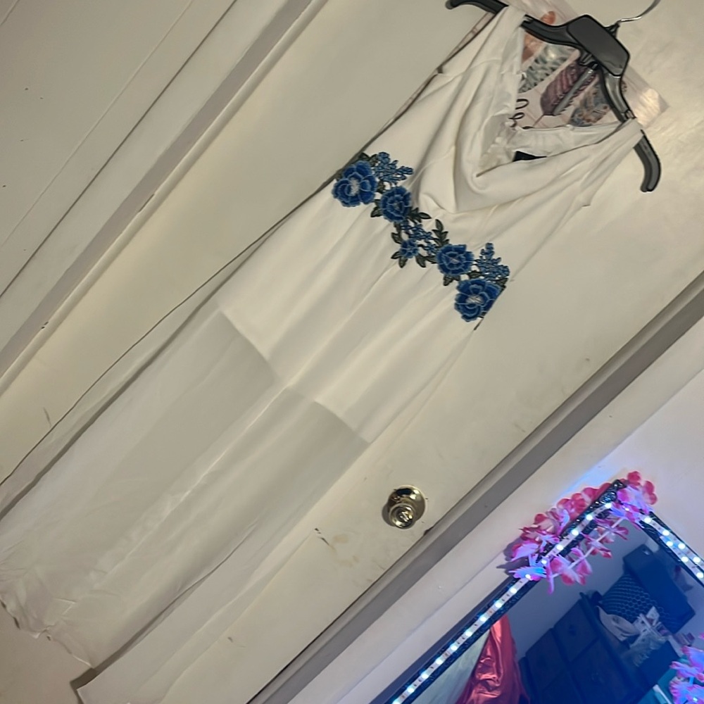 White formal prom dress with blue flowers around the middle